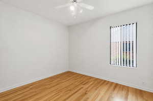Unfurnished room with light wood-style floors and ceiling fan