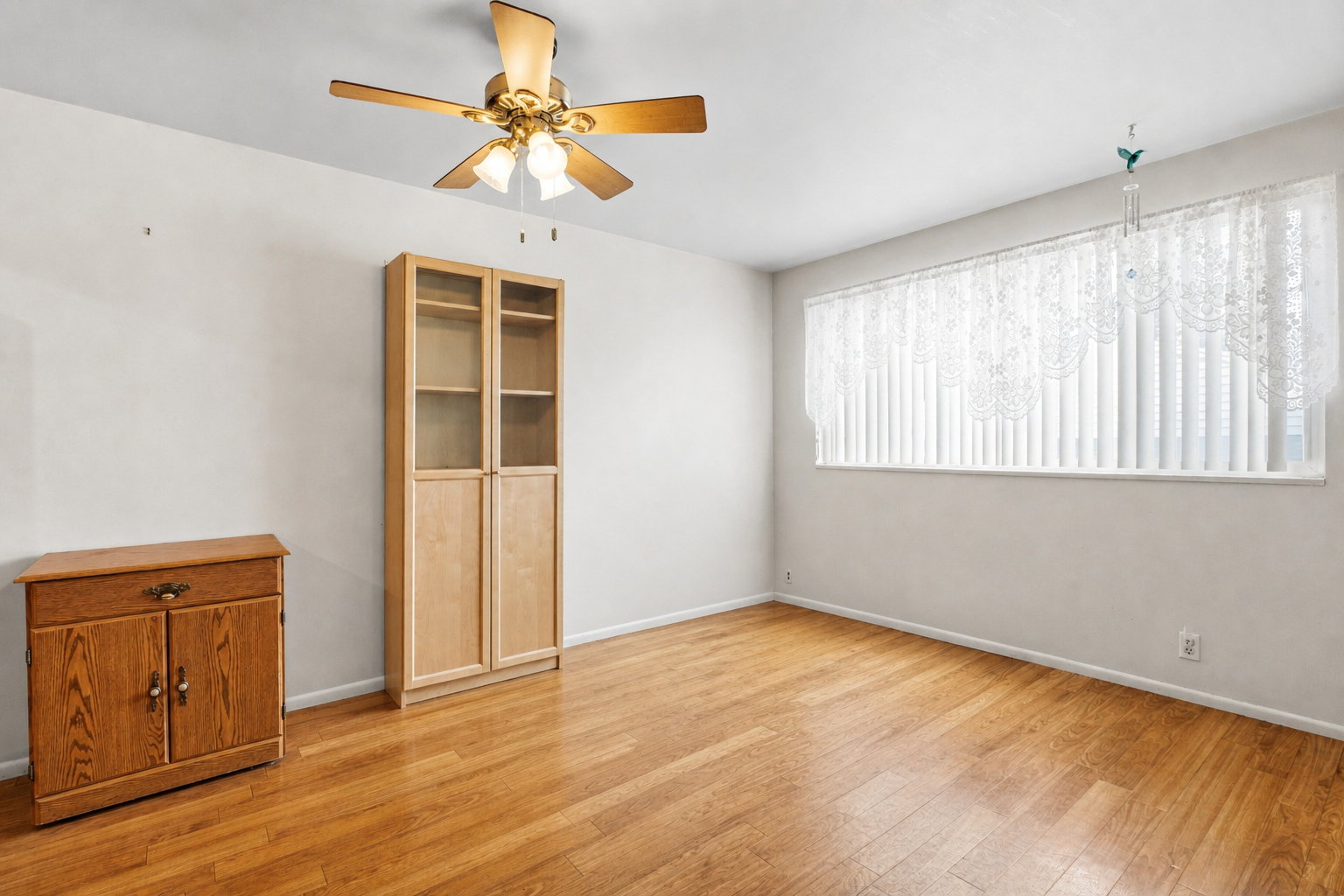 Spare room featuring ceiling fan and light wood finished floors