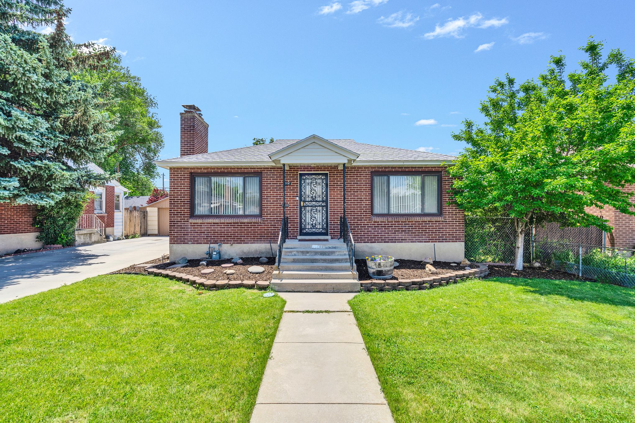 Brick exterior featuring a gabled entry