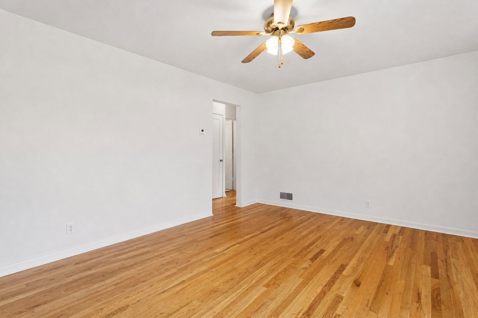 Spare room featuring light wood finished floors and a ceiling fan