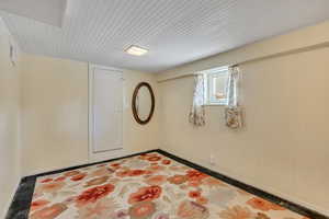 Spare room featuring wood walls and baseboards