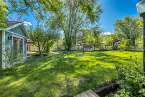 Fenced backyard with an outdoor structure
