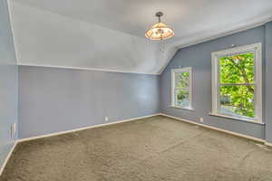 Bonus room with carpet and lofted ceiling