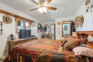 Bedroom with ceiling fan and ensuite bathroom