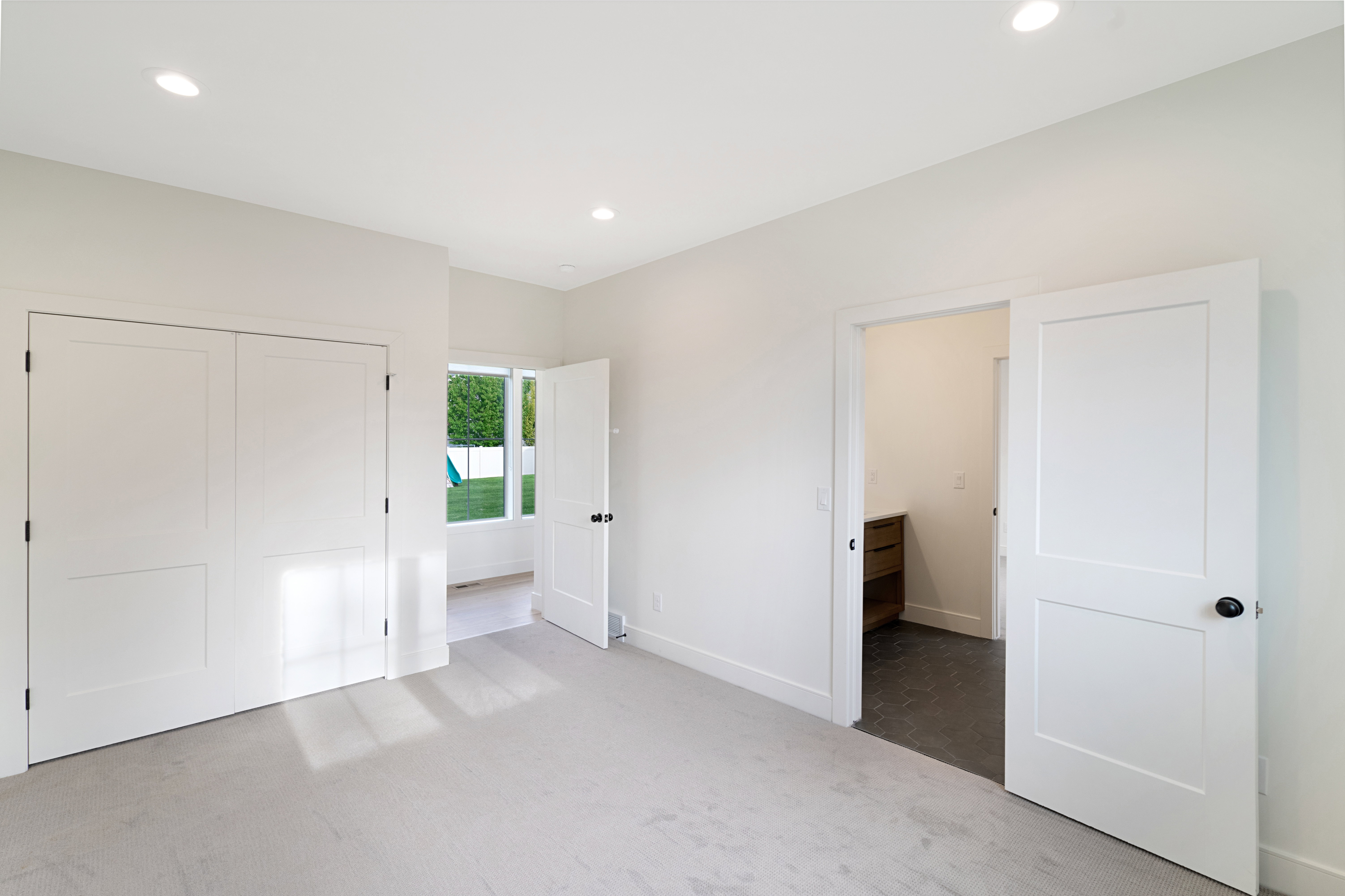 Unfurnished bedroom featuring light carpet, recessed lighting, and a closet