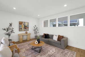 Living area featuring wood finished floors and recessed lighting