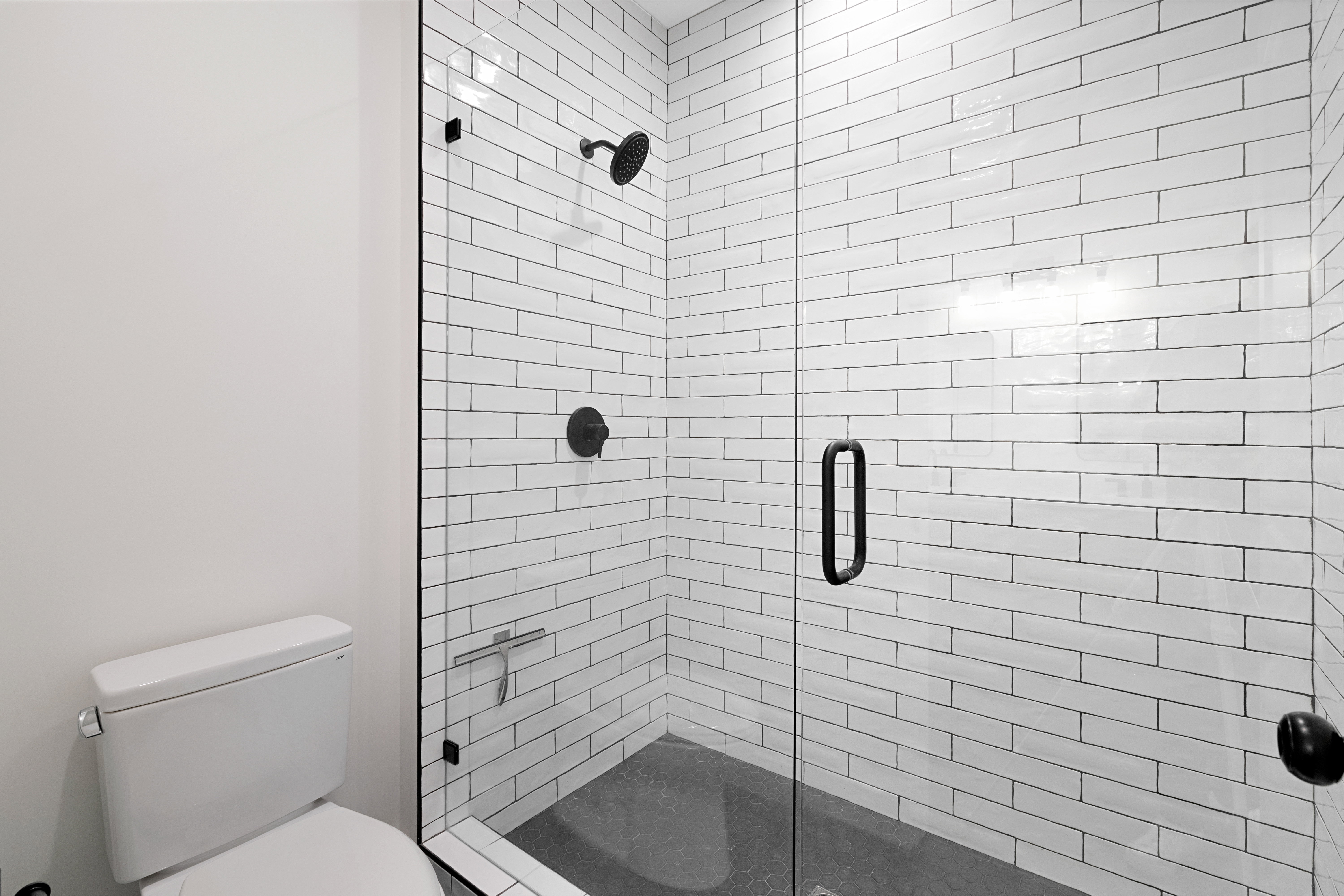 Bathroom with a stall shower and toilet