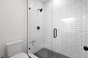 Bathroom with a stall shower and toilet
