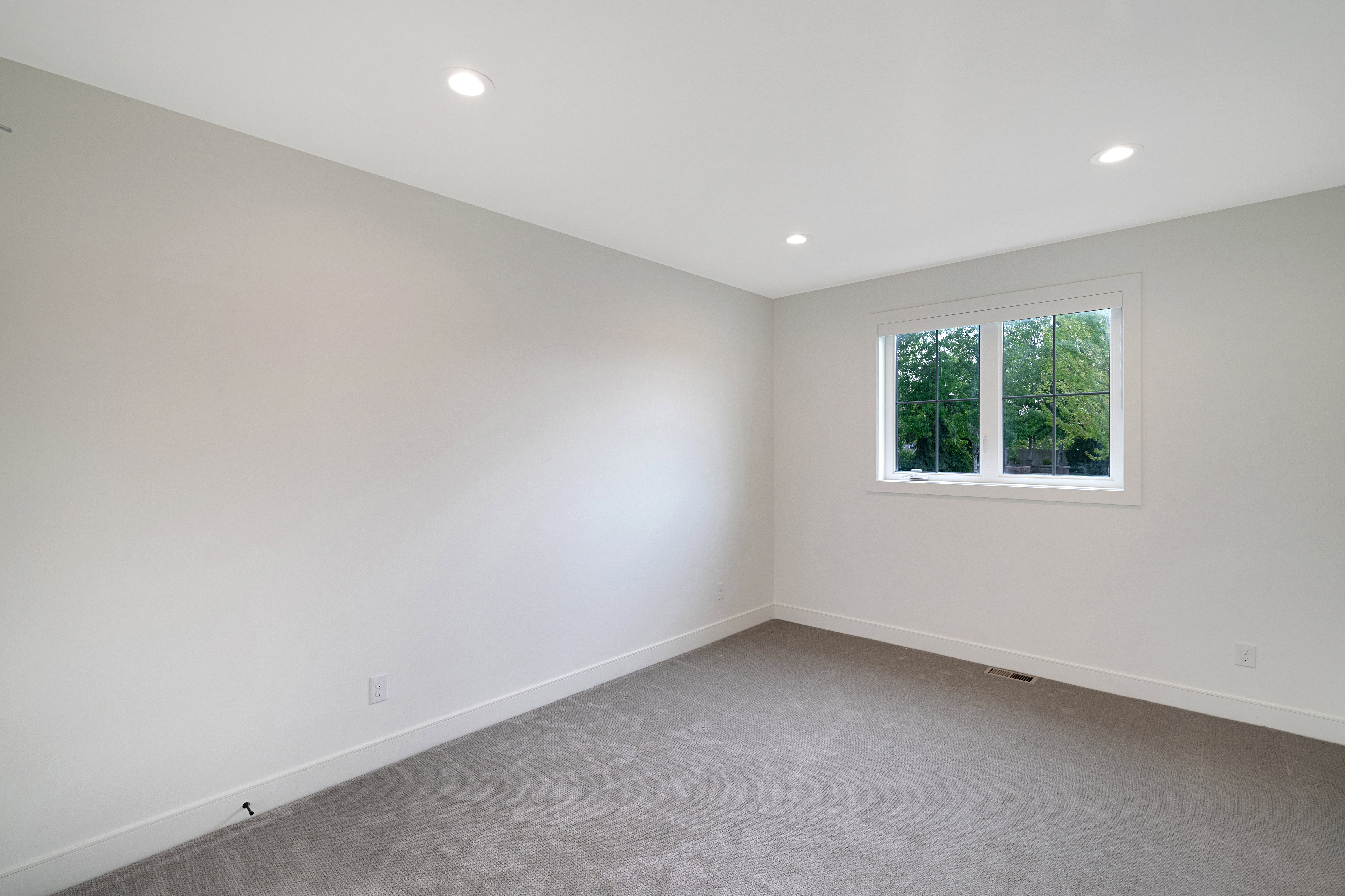 Spare room featuring light carpet and recessed lighting