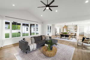 Living area featuring recessed lighting, light wood-style floors, ceiling fan, and vaulted ceiling
