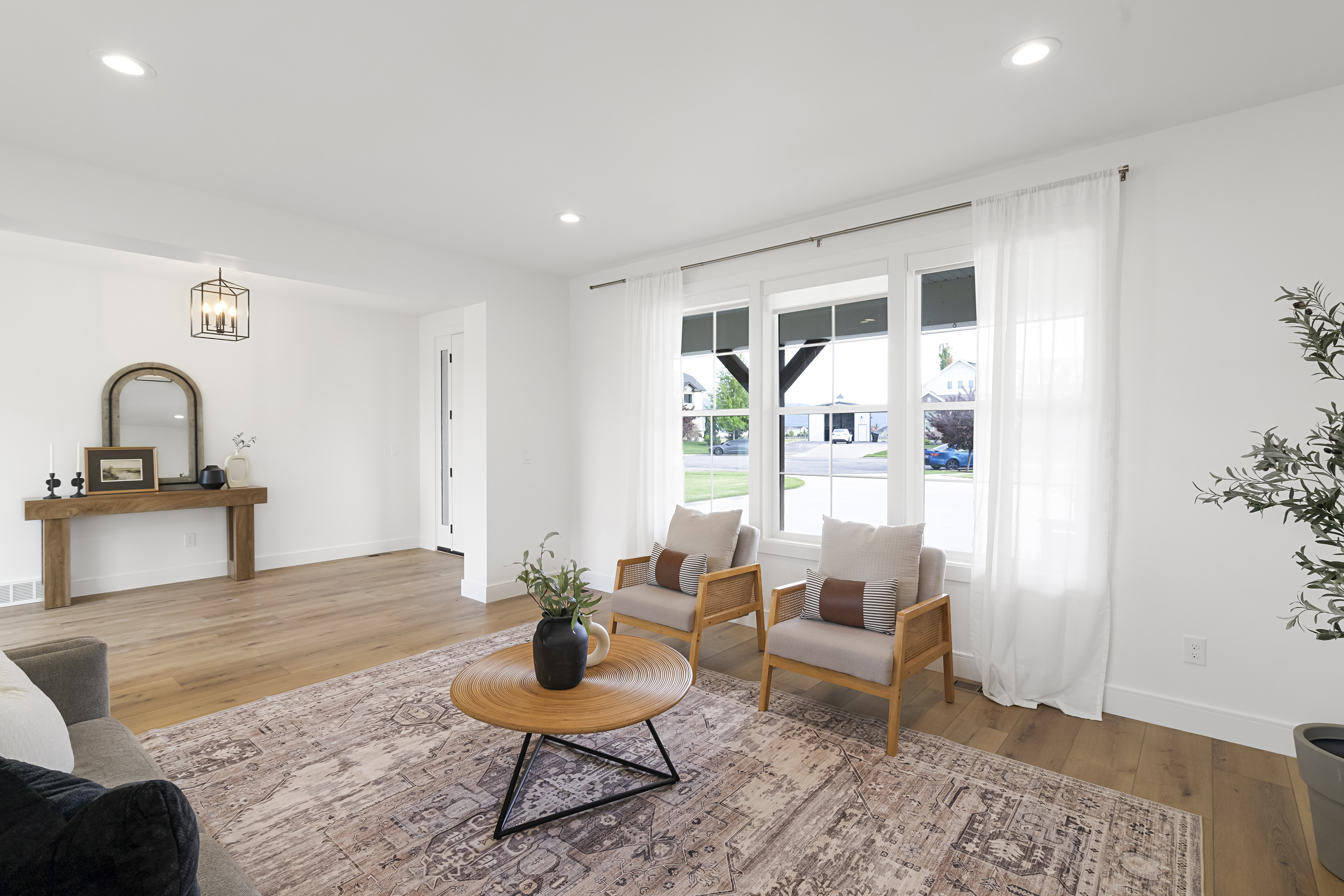 Living area with light wood-type flooring and recessed lighting