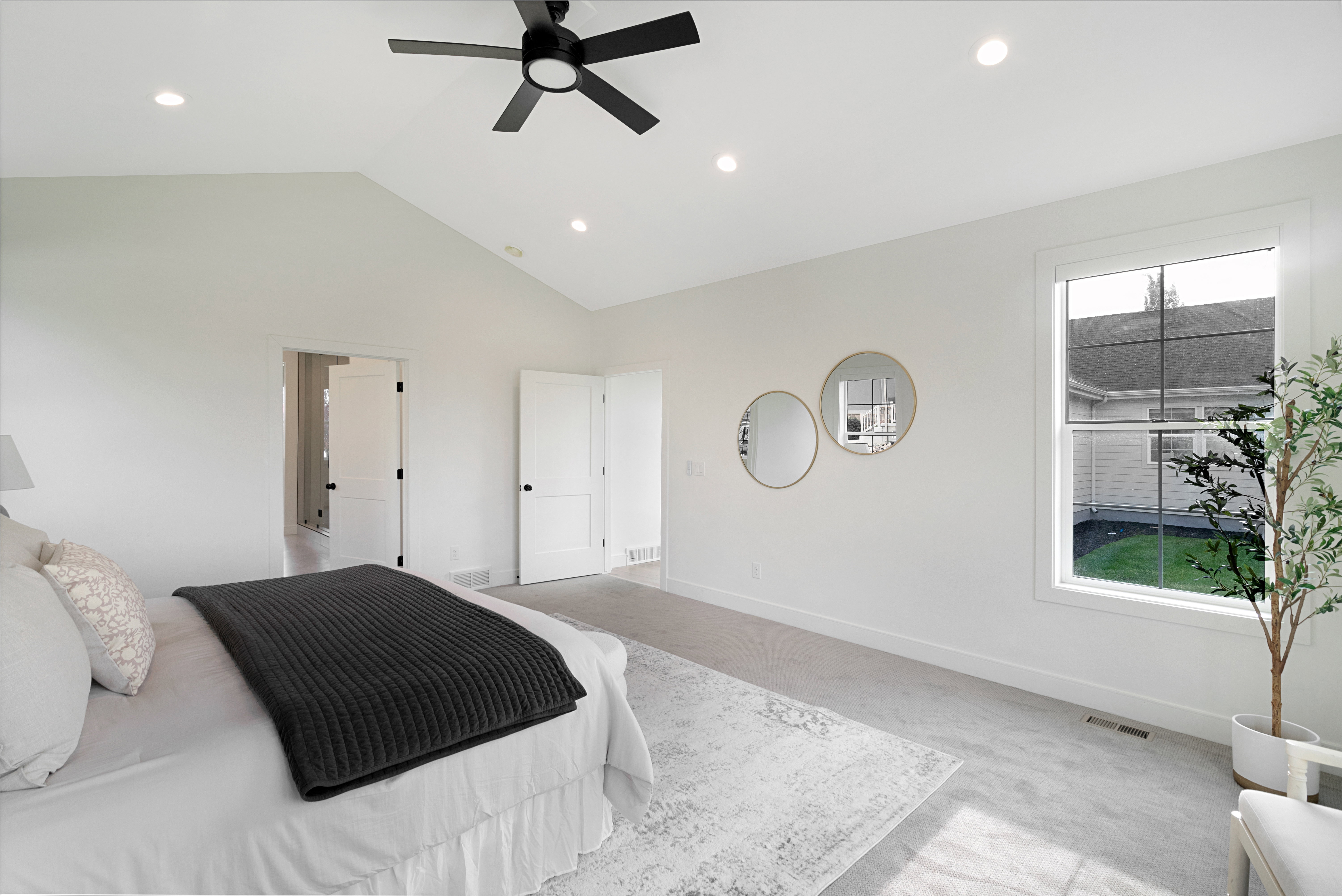 Bedroom featuring ceiling fan, recessed lighting, and a high ceiling