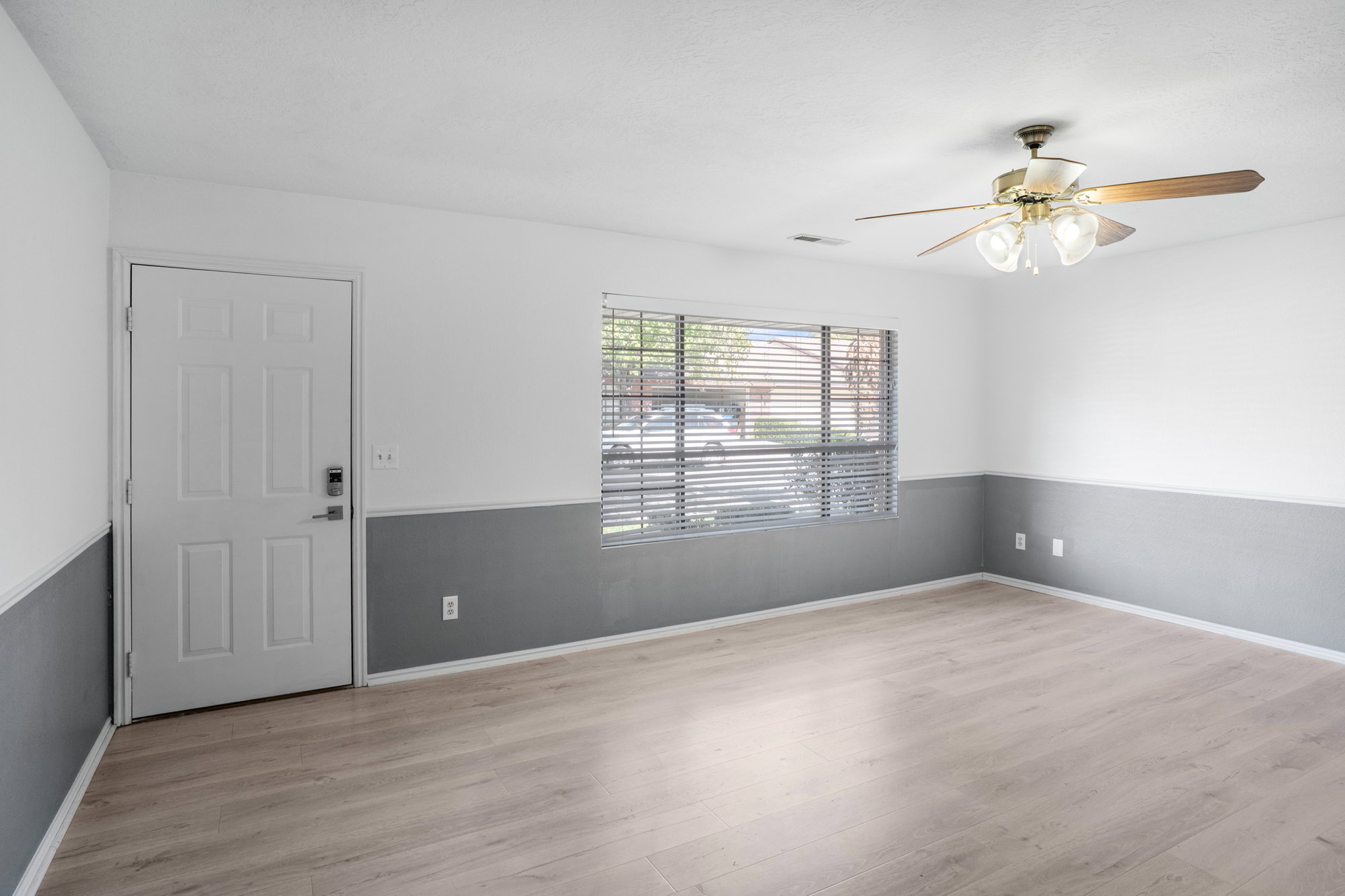 Empty room featuring a ceiling fan and light wood-style flooring