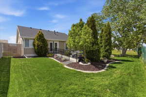 Rear view of house featuring roof with shingles and stucco siding