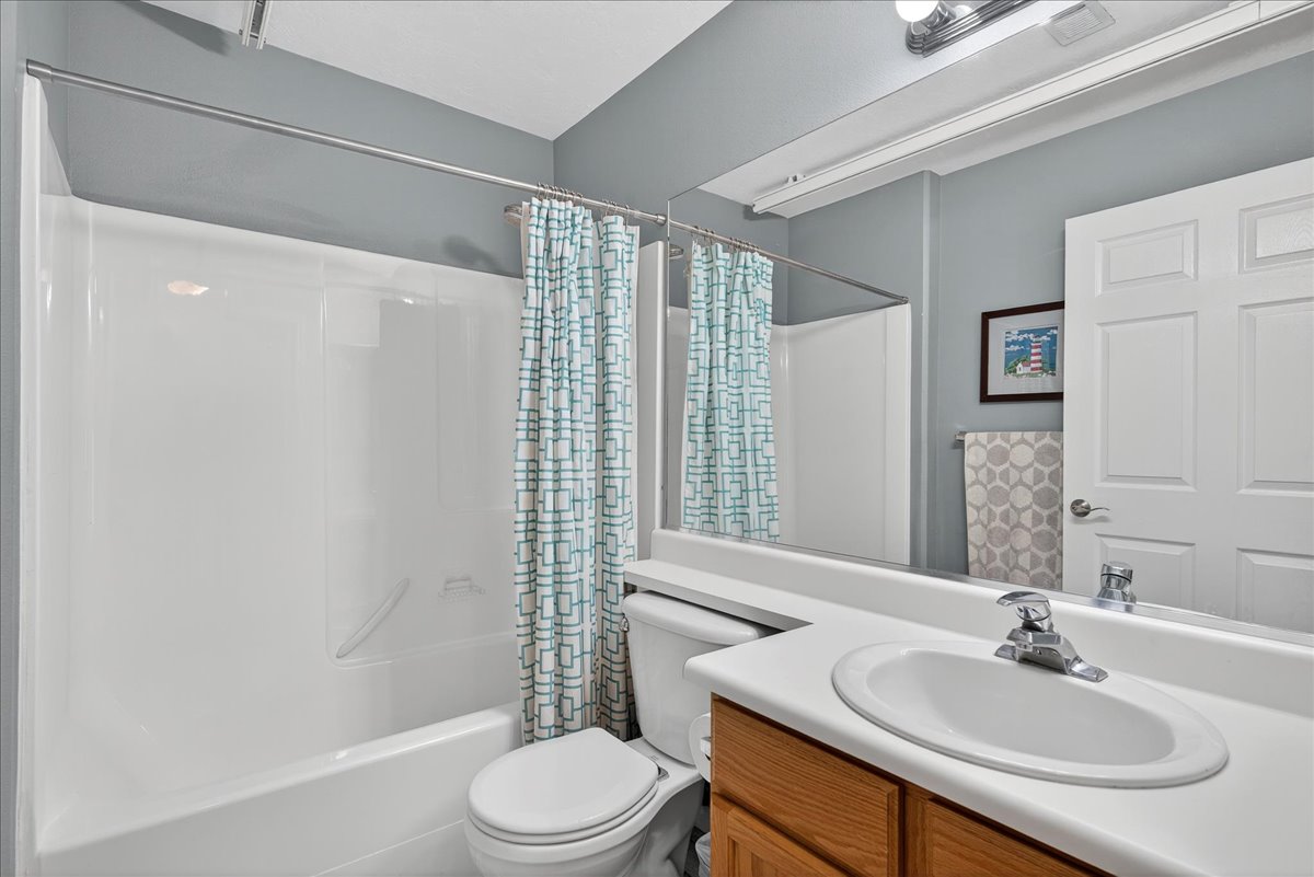 Bathroom with vanity and shower / tub combo