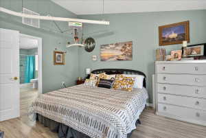 Bedroom with light wood-style flooring and baseboards