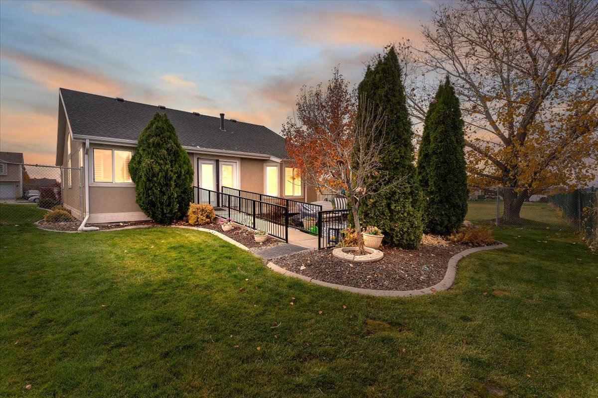 Rear view of property with roof with shingles and stucco siding