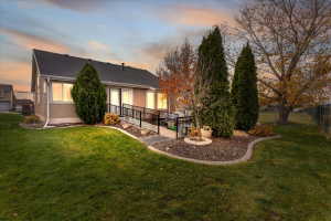 Rear view of property with roof with shingles and stucco siding