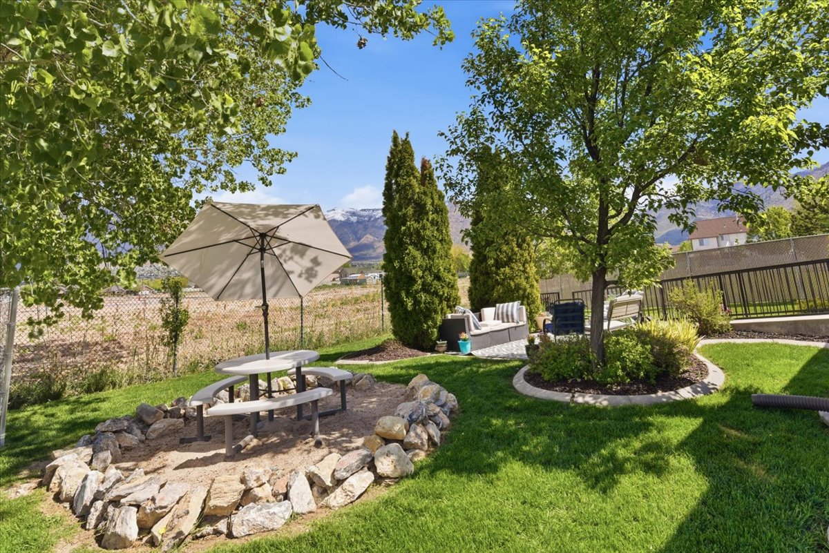Fenced backyard with a patio area, an outdoor lounge area, and a mountain view