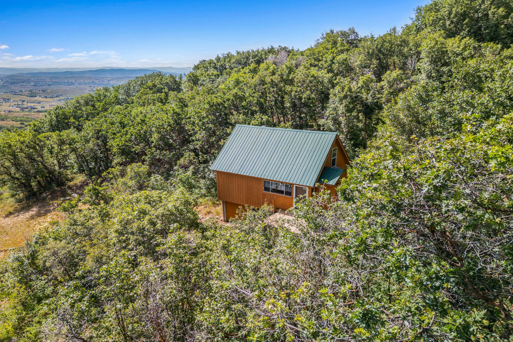 View from above of property featuring a heavily wooded area