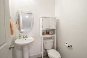 Half bathroom featuring toilet and a sink