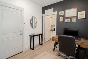 Office space featuring light wood-type flooring and baseboards
