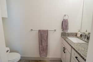 Bathroom featuring vanity and toilet
