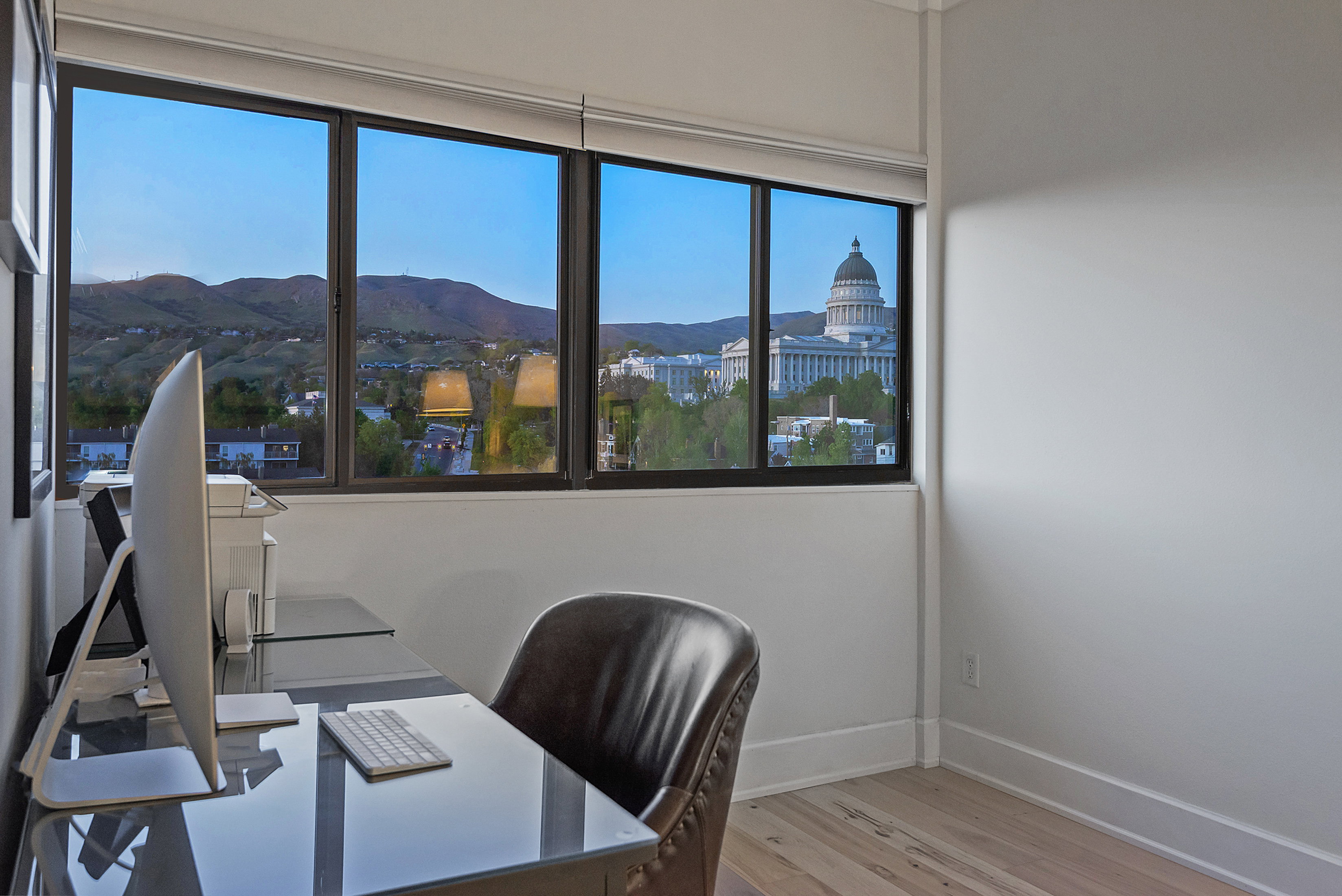 Office space featuring a mountain view and light wood finished floors