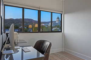 Office space featuring a mountain view and light wood finished floors