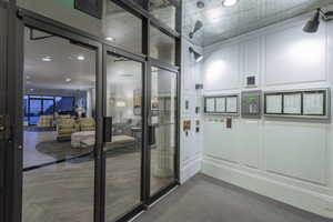 Doorway to outside with a decorative wall and recessed lighting