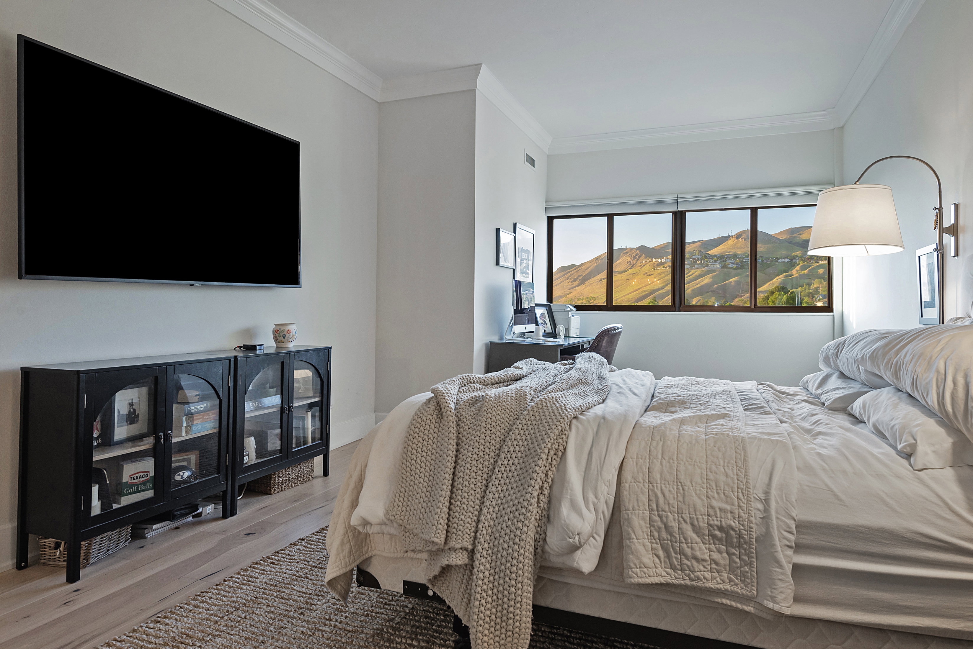 Bedroom featuring ornamental molding, wood finished floors, and a mountain view