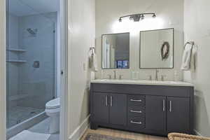 Bathroom with double vanity and a shower stall