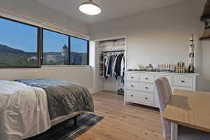 Bedroom featuring light wood-style flooring and baseboards