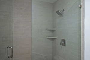 Full bathroom with a shower stall