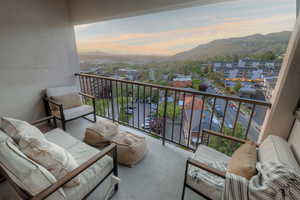 Balcony at dusk with an outdoor living space and a mountain view