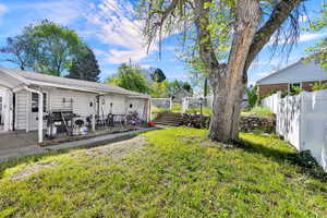 Fenced yard with a patio area