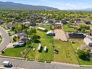 Aerial view of property's location featuring a mountainous background and nearby suburban area