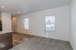Unfurnished living room featuring dark wood-style floors