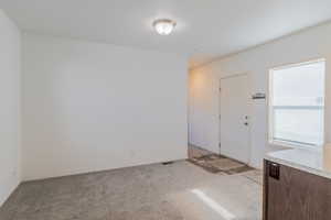 Entrance foyer with light carpet