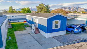 Manufactured / mobile home featuring a mountain view and a front yard