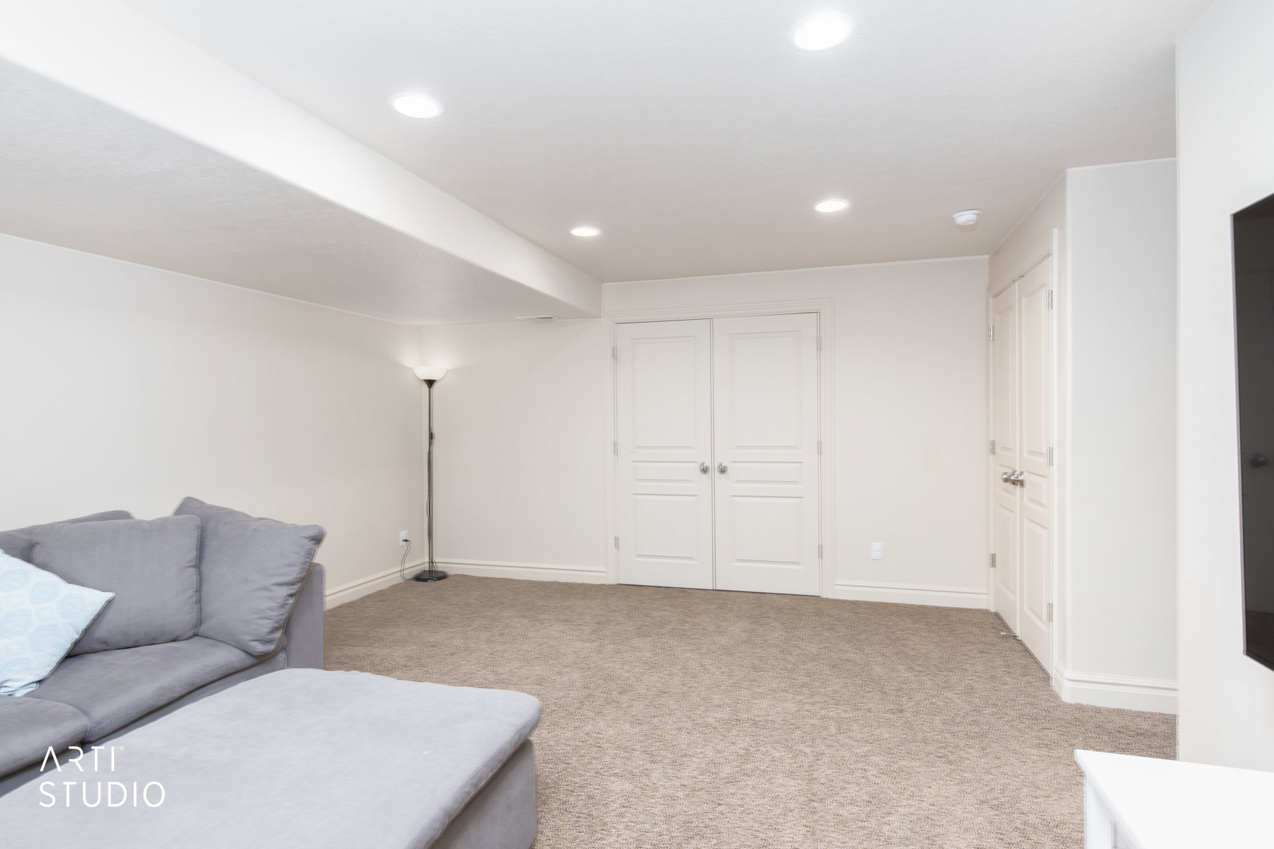 Living area featuring light colored carpet and recessed lighting