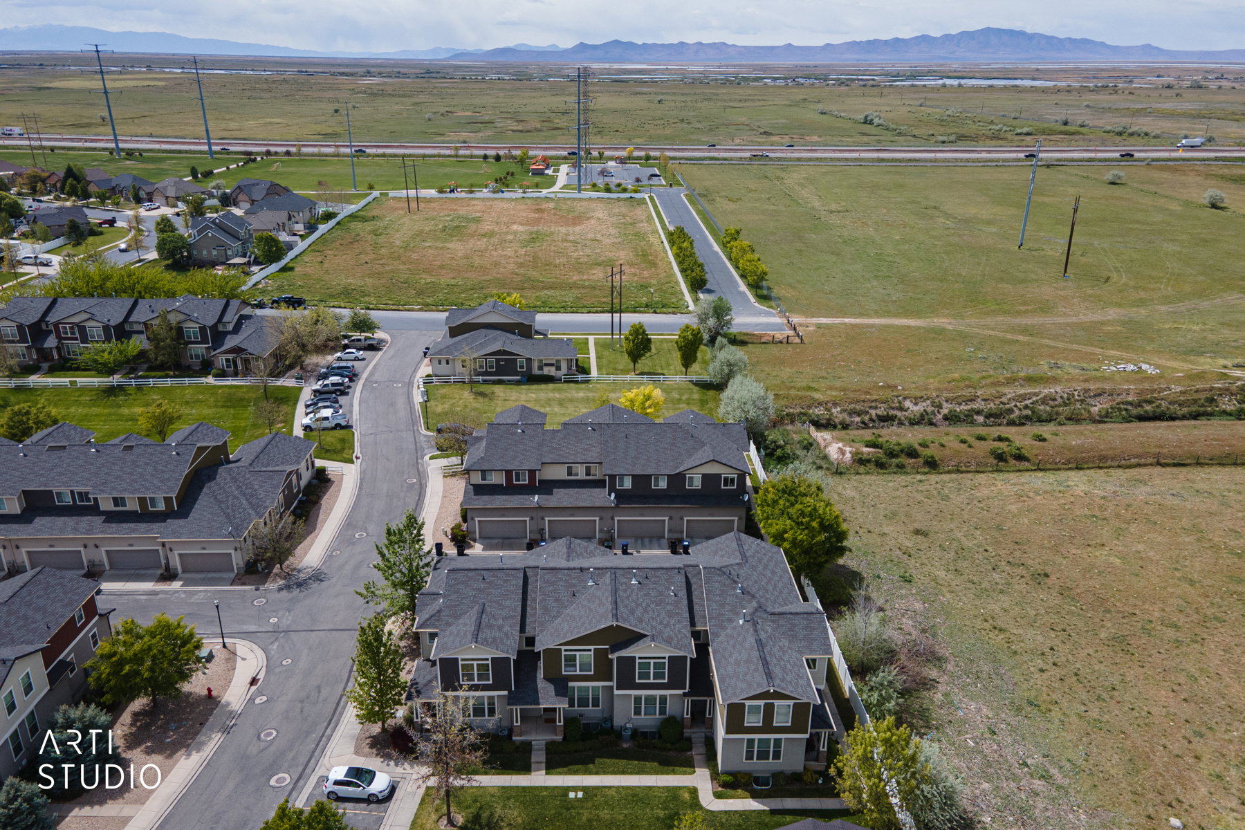 Aerial view of sparsely populated area featuring mountains and nearby suburban area
