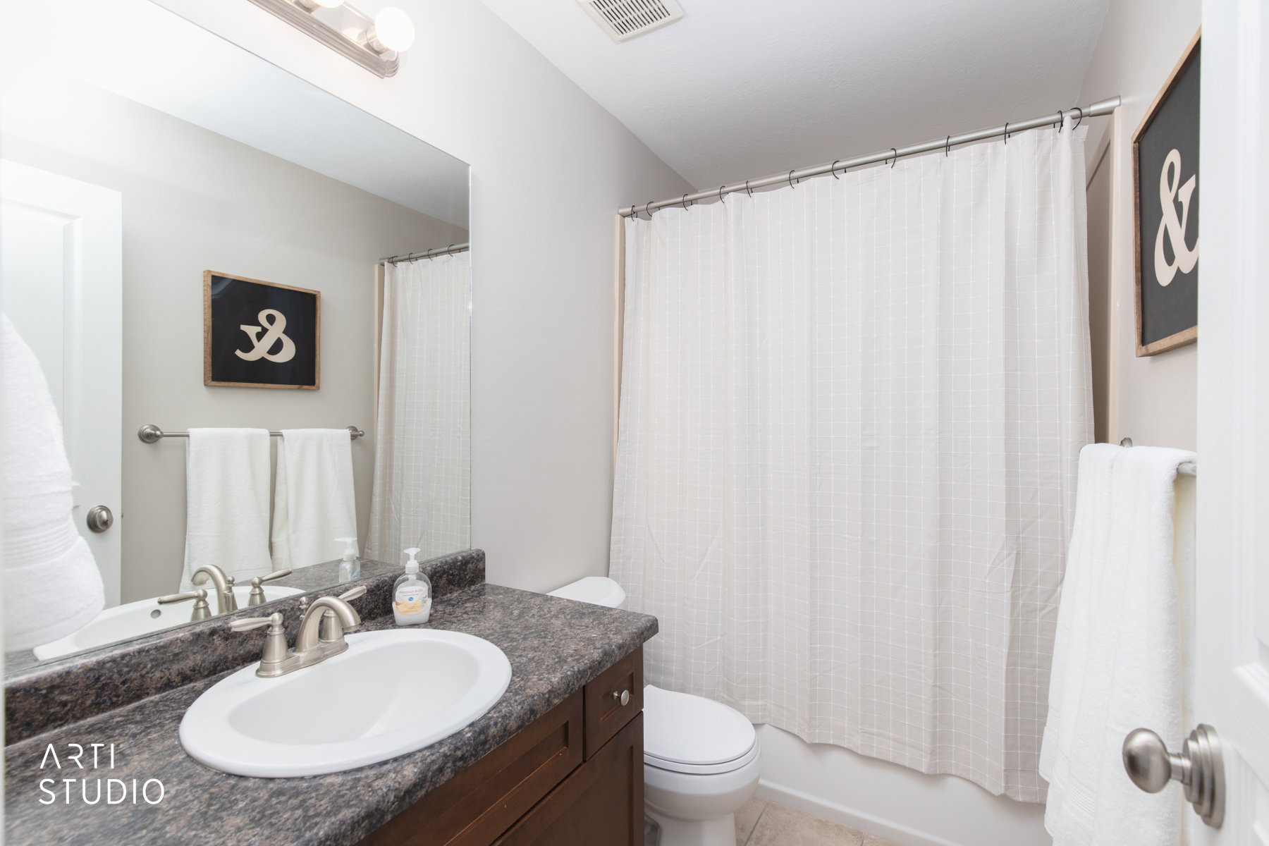 Upstairs bathroom with vanity, shower / bathtub combination with curtain, and light tile patterned floors