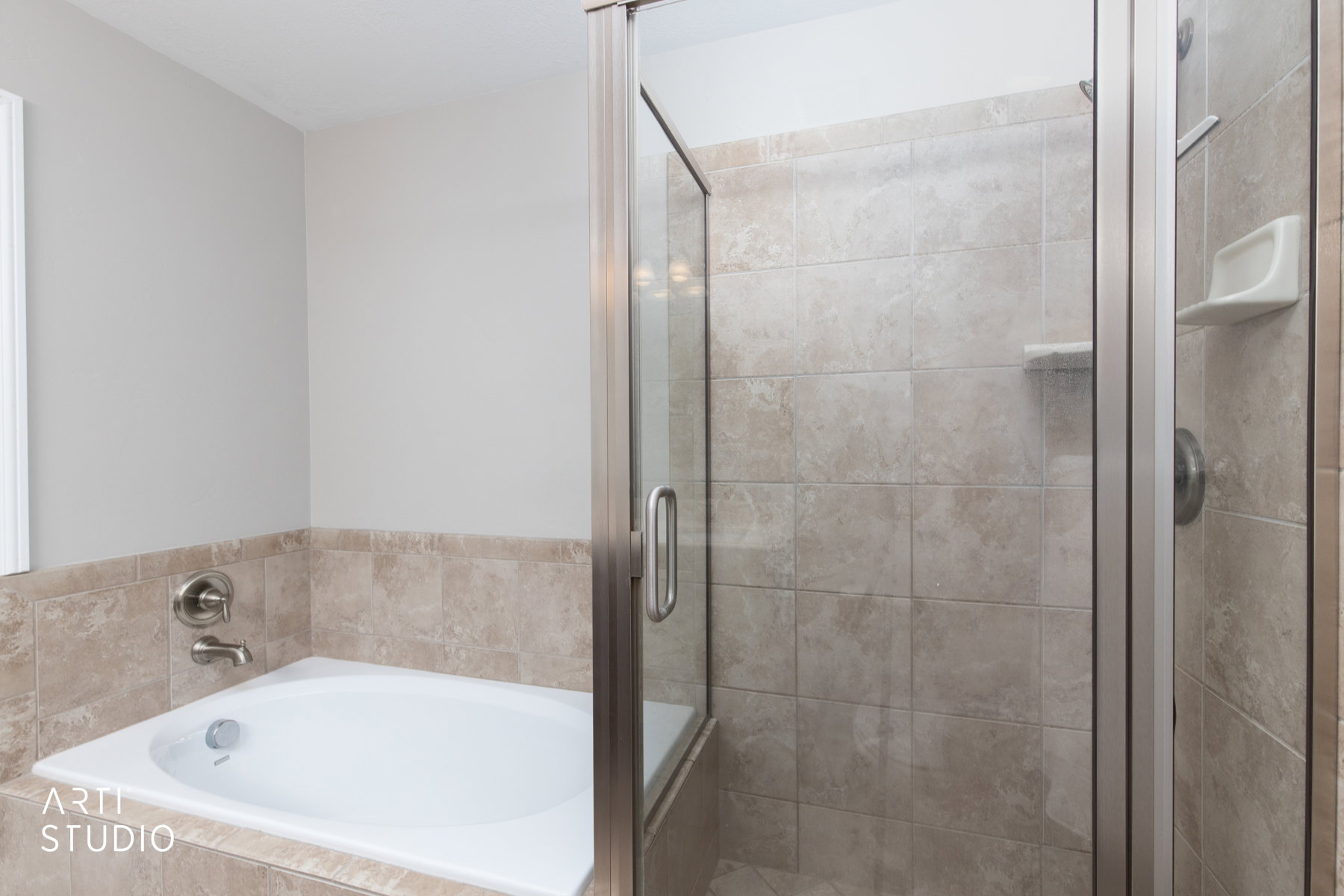 Primary bathroom with a shower and a soaker tub