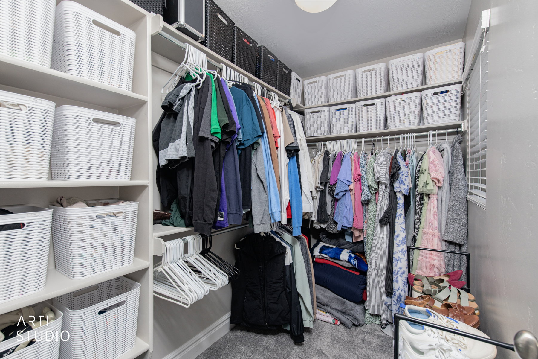 Walk in closet featuring light colored carpet