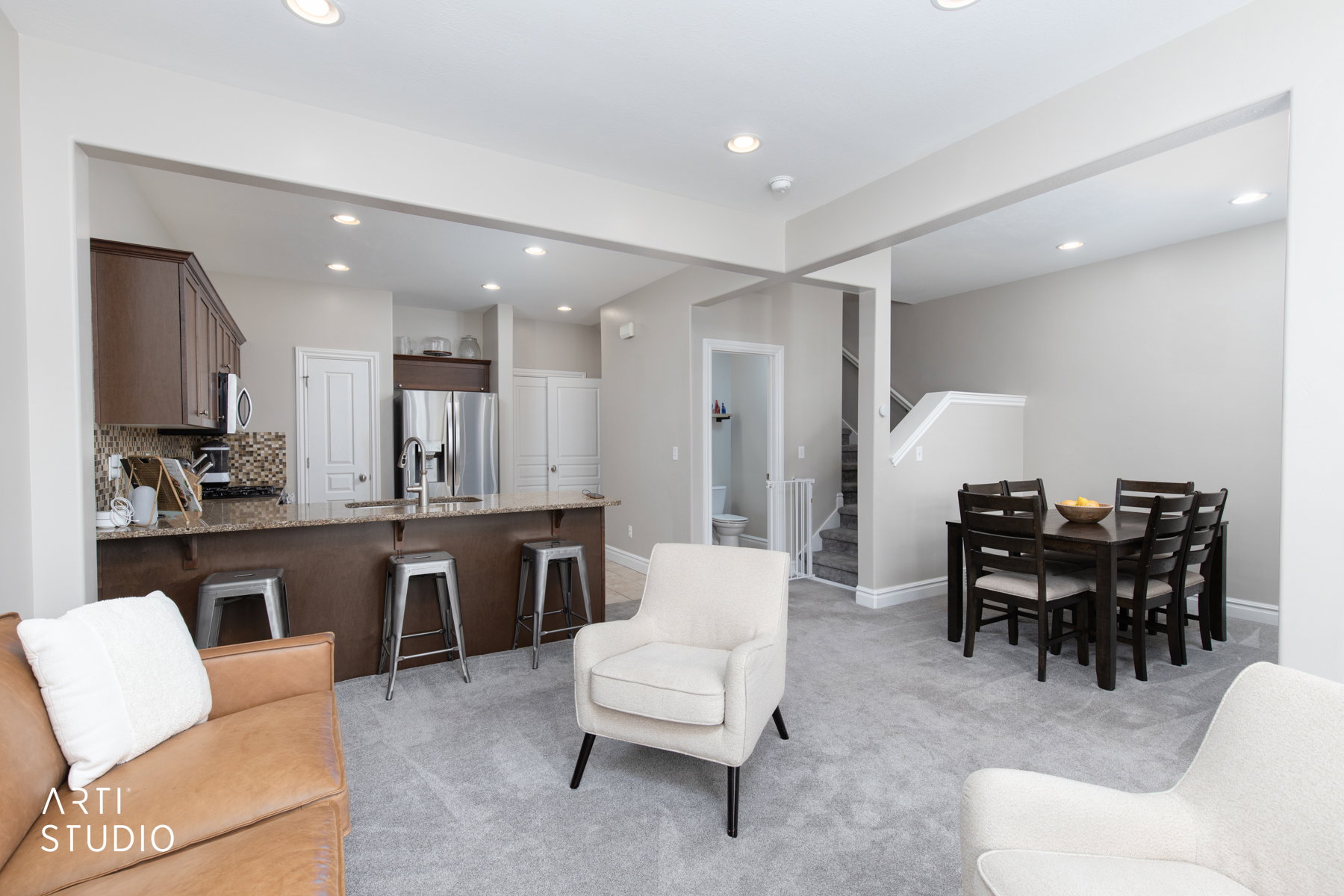 Living room with light colored carpet and recessed lighting