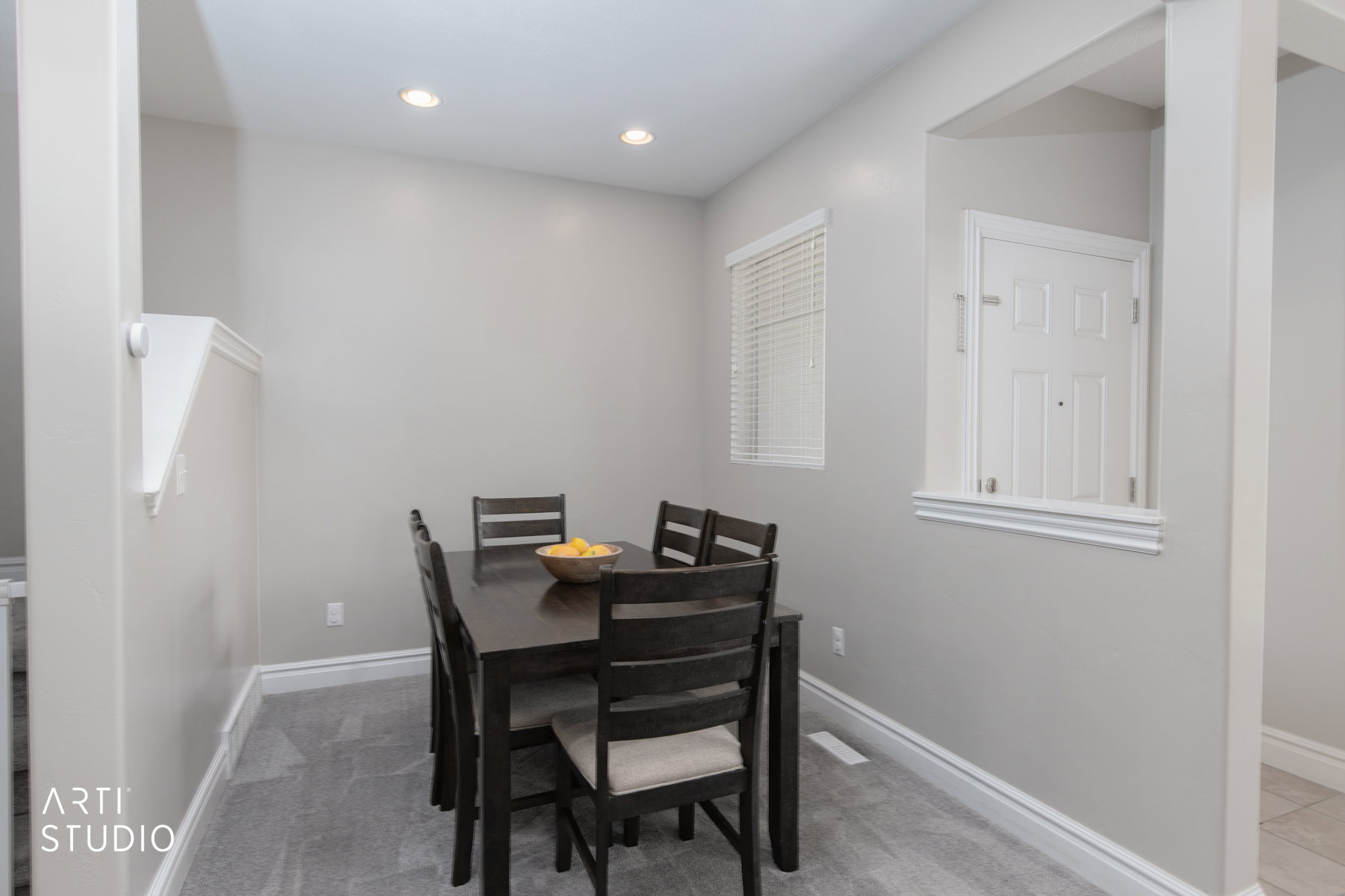 Dining space with light carpet and recessed lighting