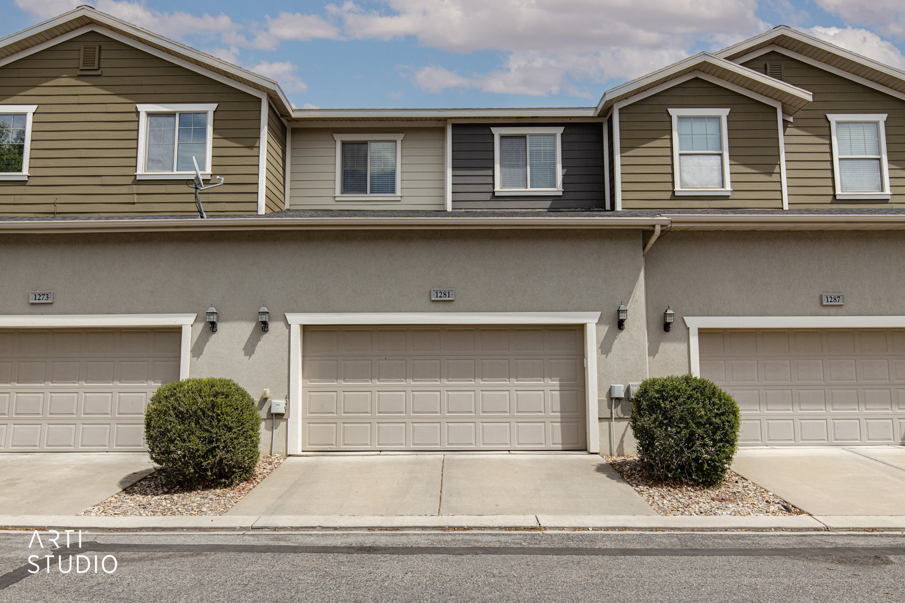 Stucco siding, concrete driveway, and a garage