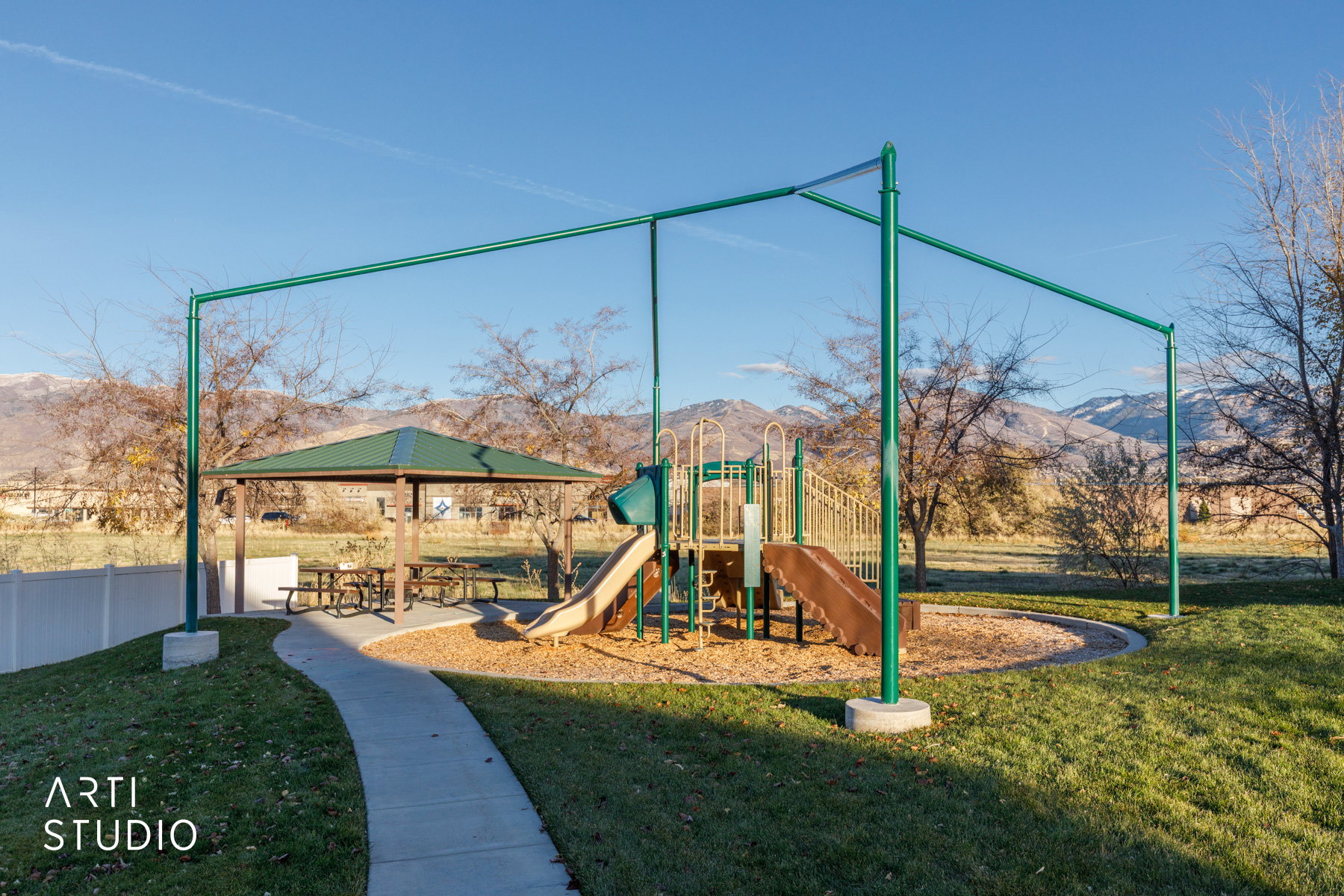 Community playground with a yard and a mountain view