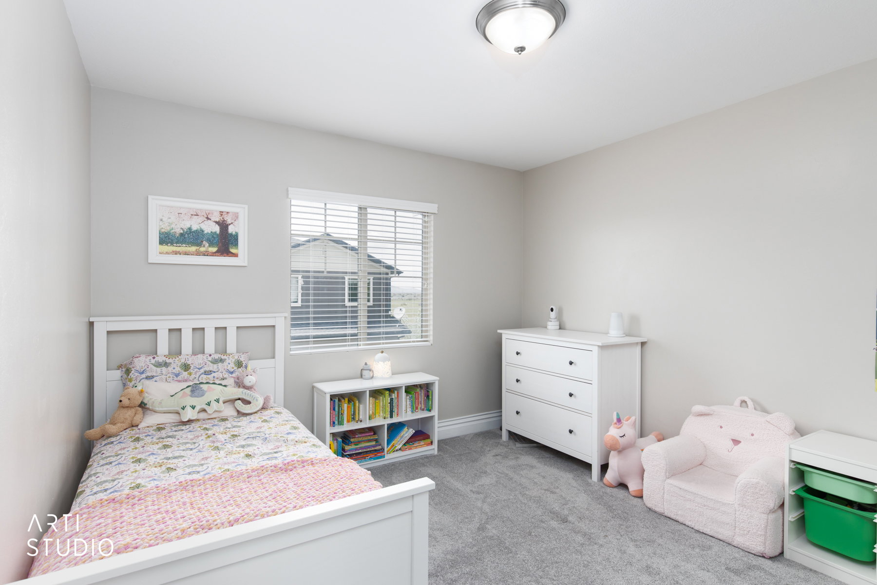 Bedroom featuring light carpet and baseboards